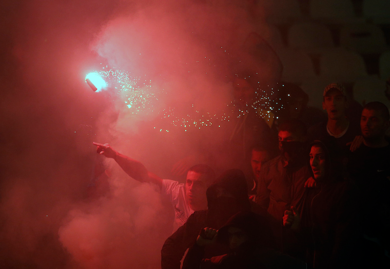 Illustration for article titled Smoke, Flares, Riot Police In Belgrade Derby Make For Haunting Photos